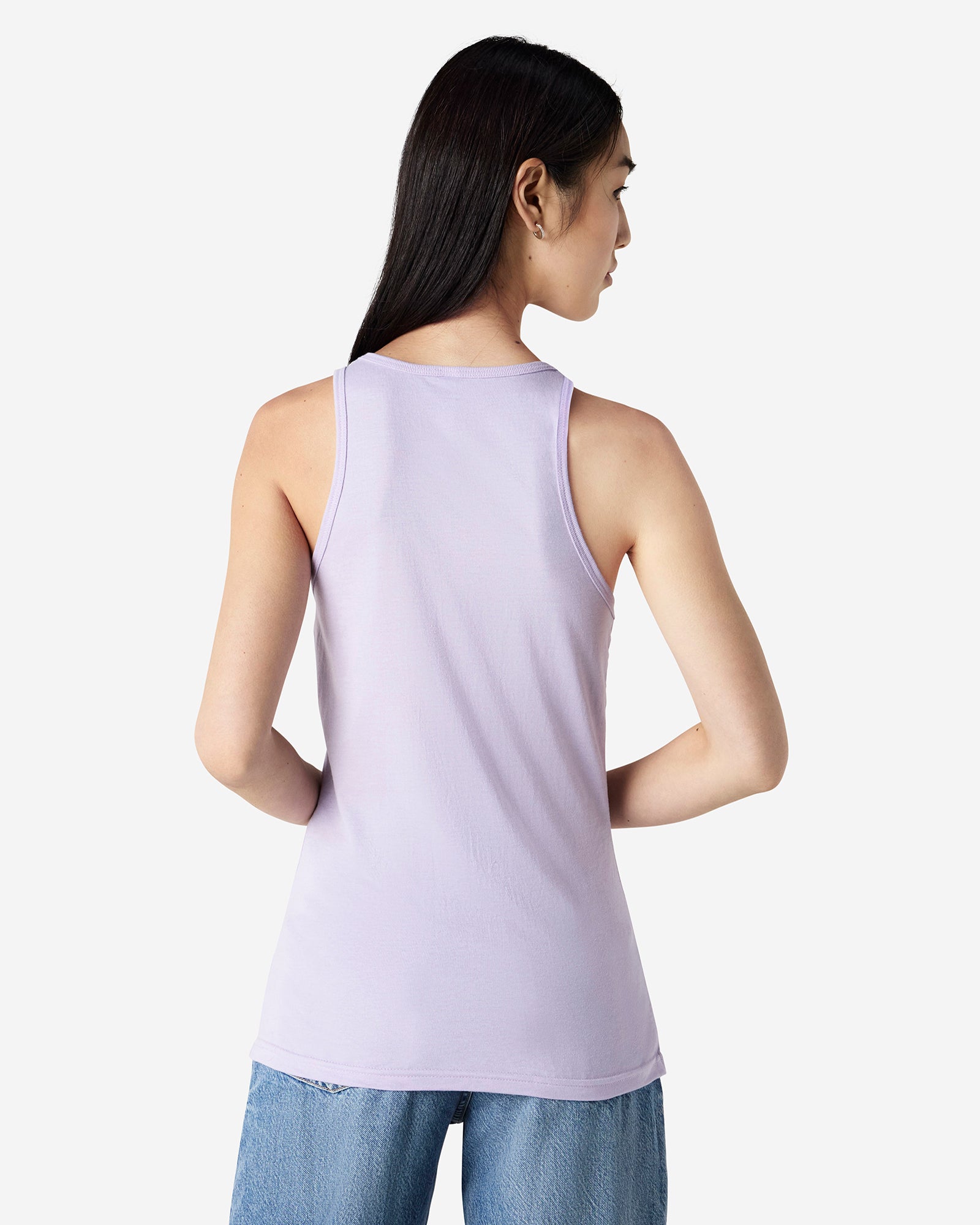 Back view of woman wearing lilac coloured American Apparel Racer Neck Ribbed Tank Top looking right with hands in front