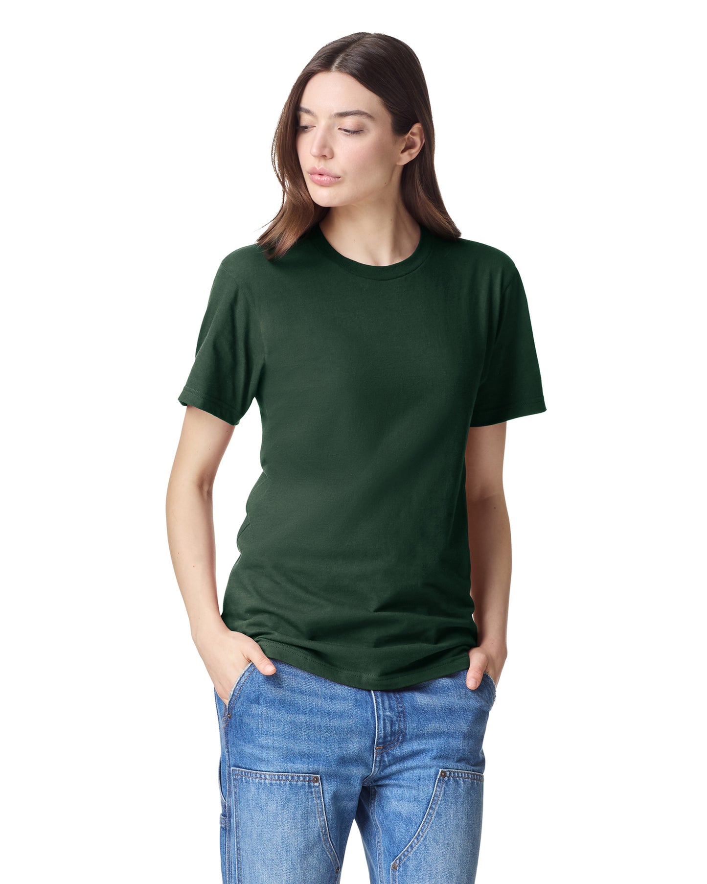 Front view of youth wearing a forest coloured American Apparel Fine Jersey Youth T-shirt looking down to the right with both hands in pockets