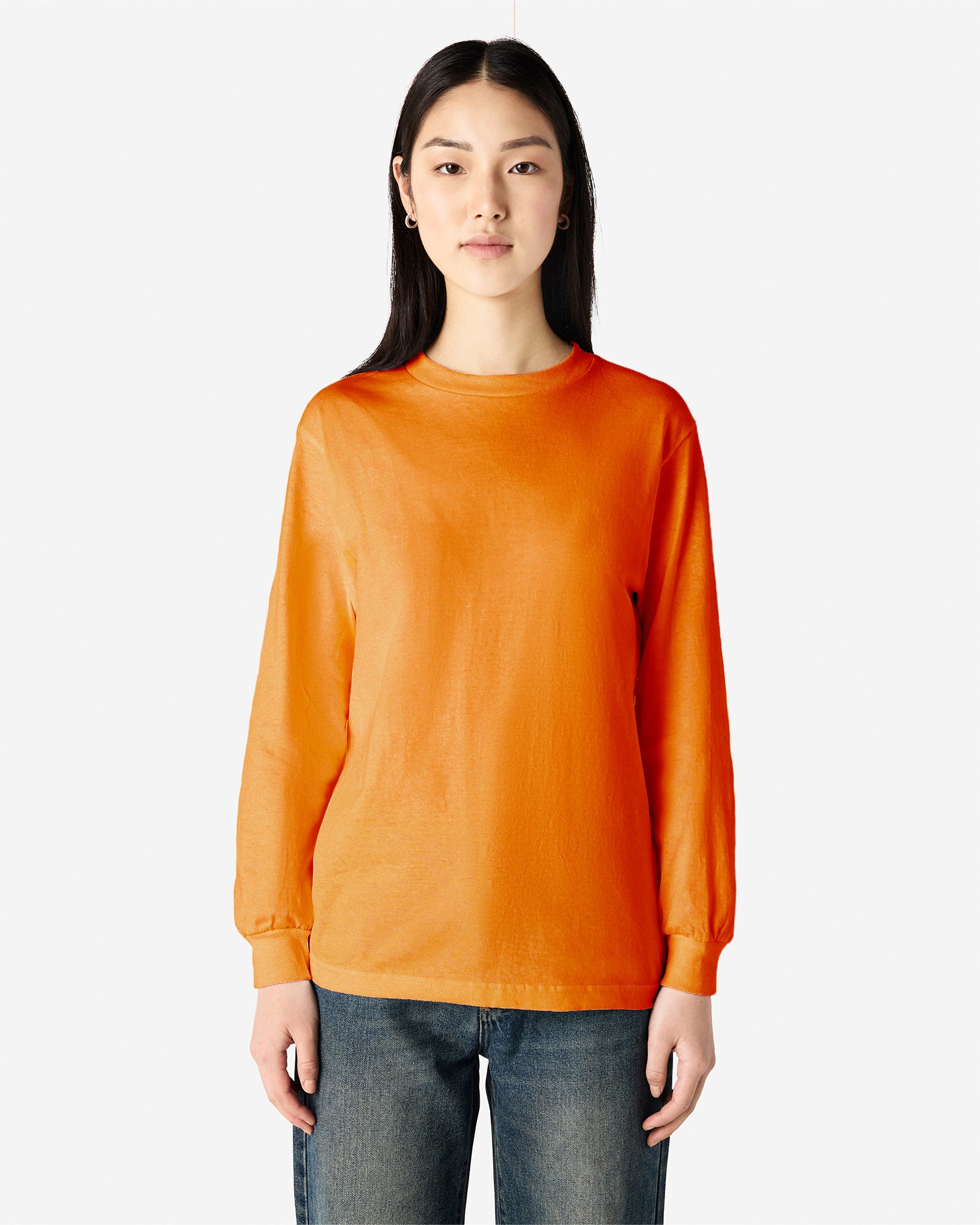 Front view of woman wearing orange American Apparel Heavyweight Long Sleeve Unisex Crew Neck T-shirt looking straight ahead