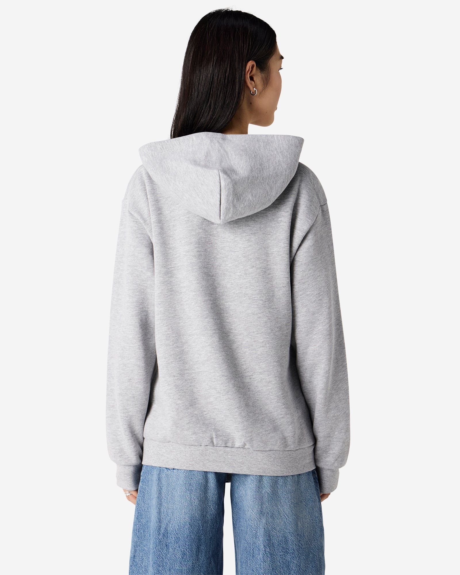 Back view of woman wearing grey American Apparel Zip-Up Hoodie looking to the right