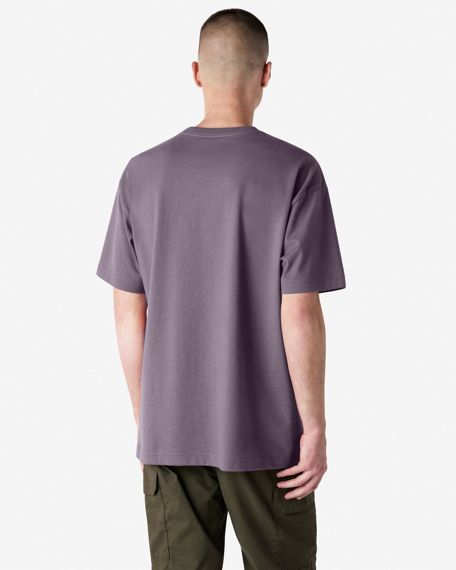 Back view of man wearing violet coloured American Apparel Super Heavyweight T-Shirt with arms by side