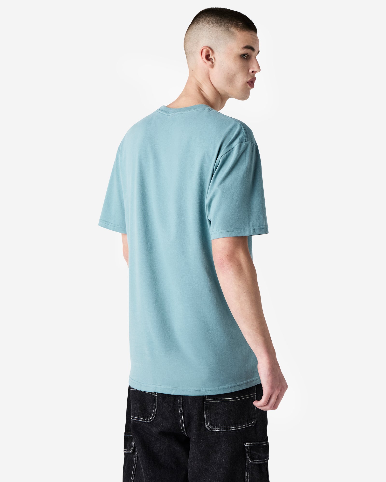 Back view of man wearing sueded arctic coloured American Apparel Unisex Sueded T-Shirt looking over right shoulder