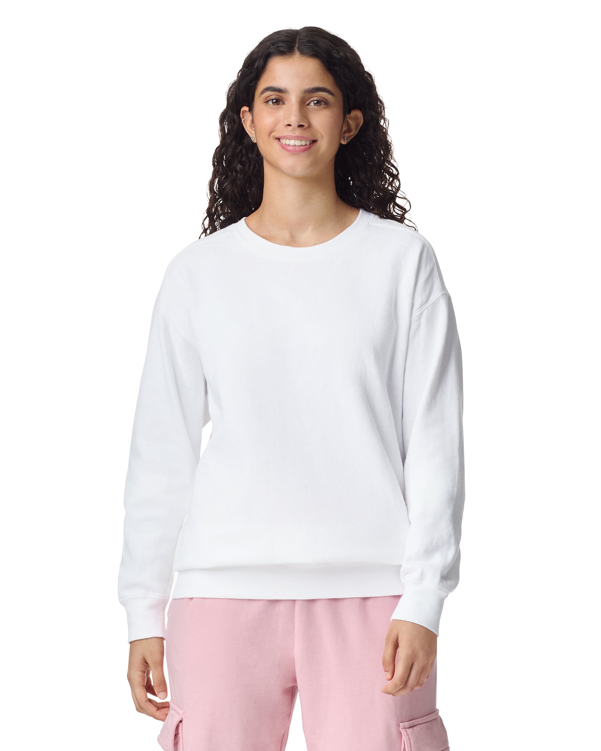 Front view of woman wearing unisex white Comfort Colors Crewneck Sweatshirt smiling looking straight ahead