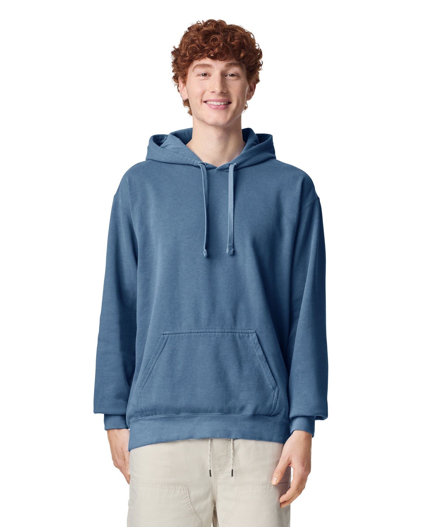Front view of man wearing blue jean coloured Comfort Colors Hoodie smiling looking straight ahead