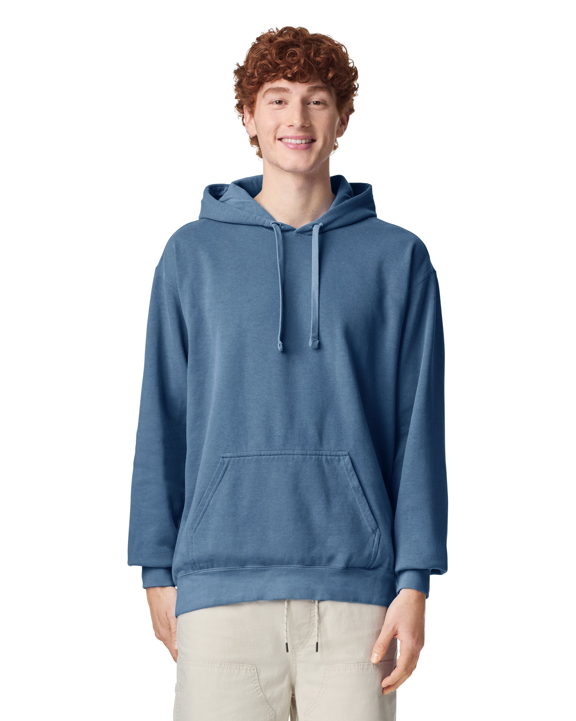 Front view of man wearing blue jean coloured Comfort Colors Hoodie smiling looking straight ahead