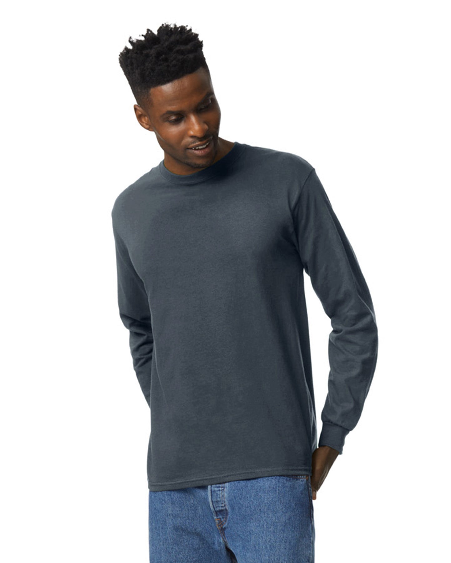 Front view of man wearing dark heather Gildan Adult Ultra Cotton Long Sleeve T-Shirt looking down left with hands behind