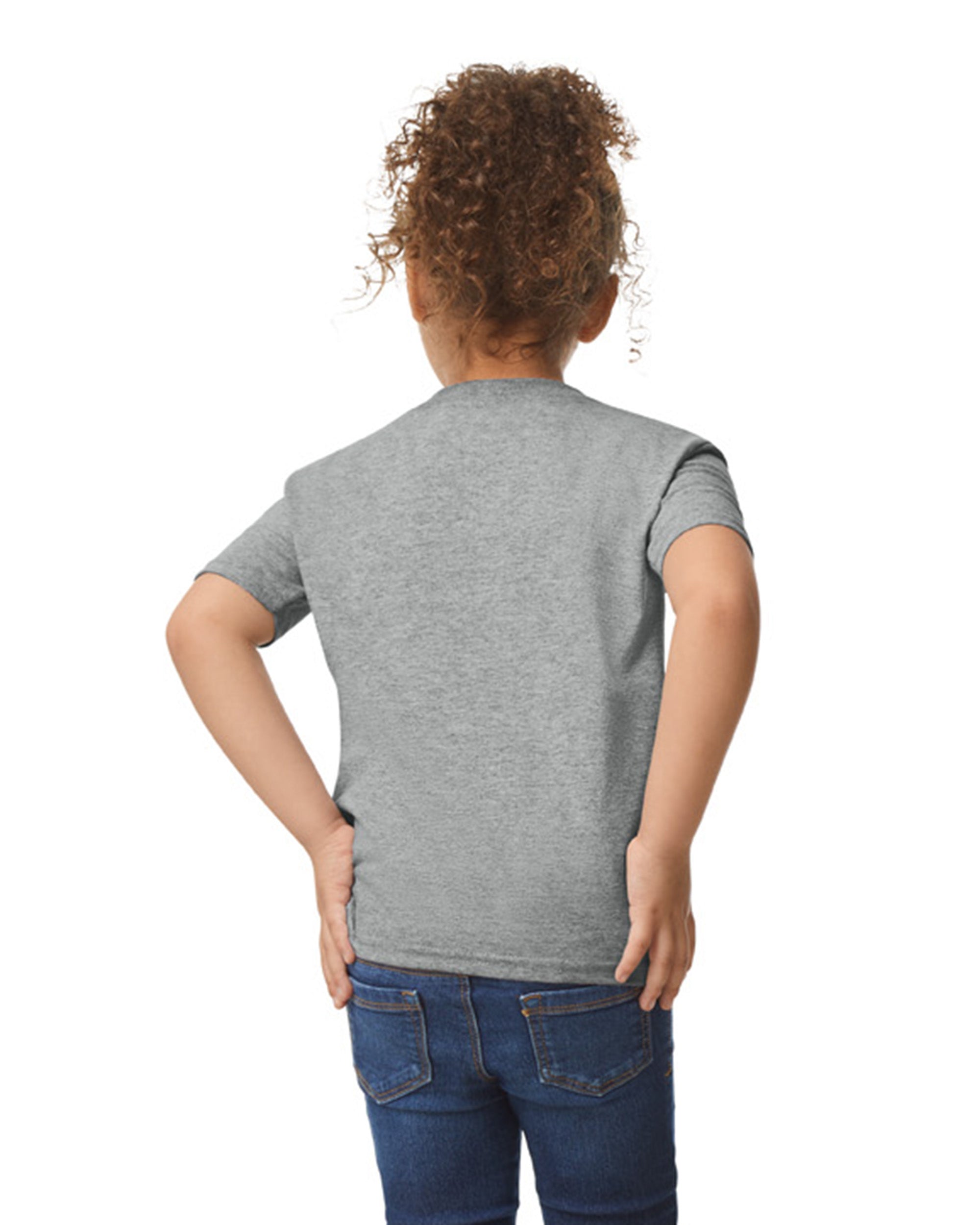 Back view of child wearing grey Gildan 5100P Heavy Cotton Childrens T-Shirt with hands placed on hips