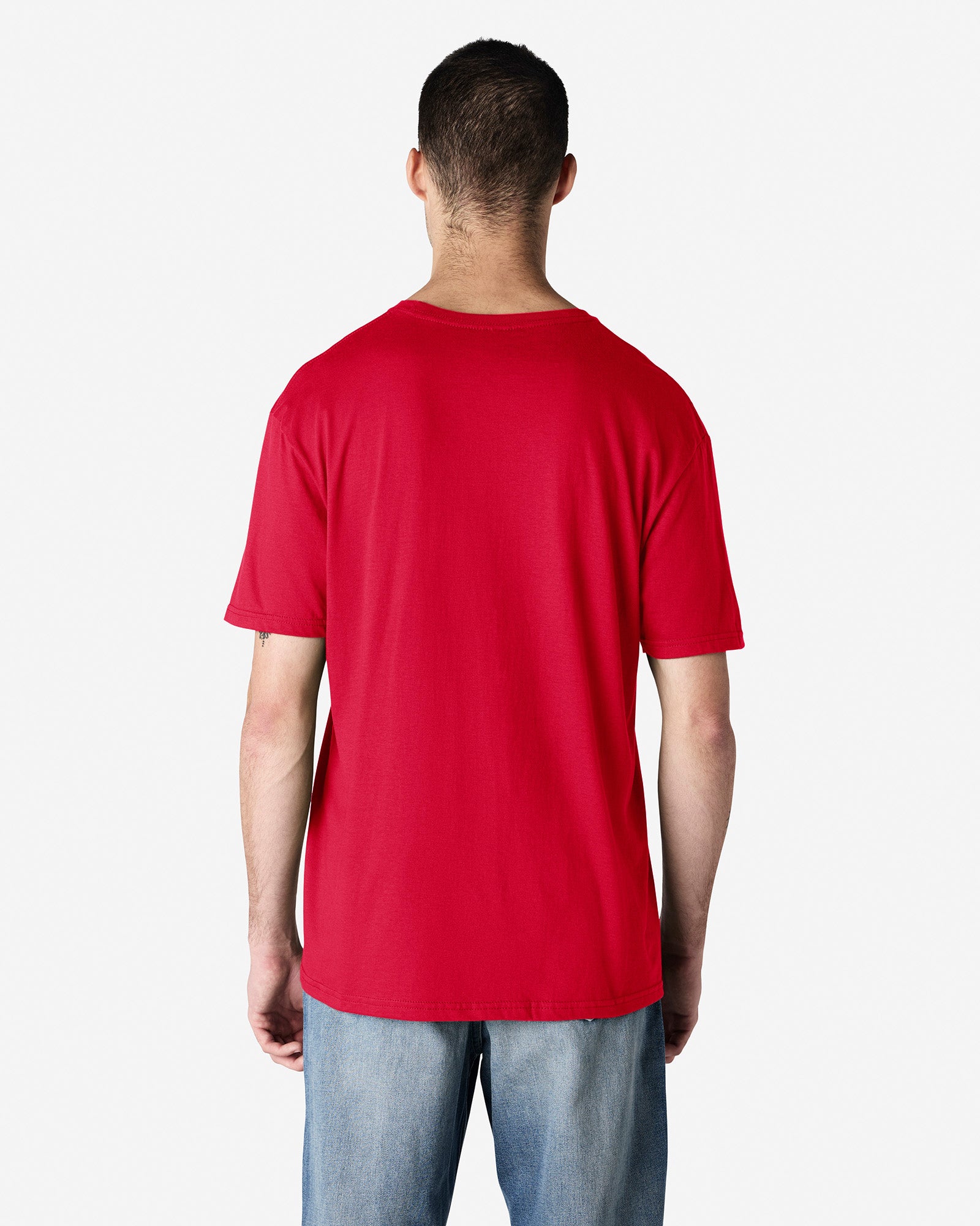Back view of man wearing cherry red Gildan Adult Softstyle T-Shirt with hands by side