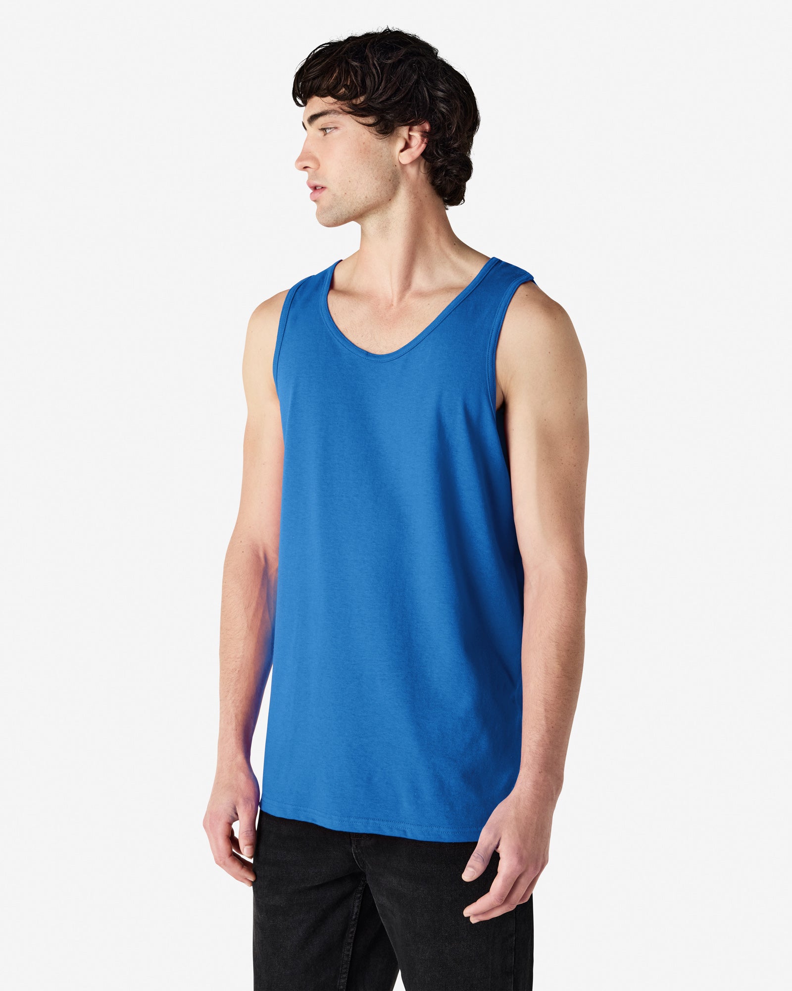 Front view of man wearing royal coloured Gildan Heavy Adult Tank Top standing slightly side on