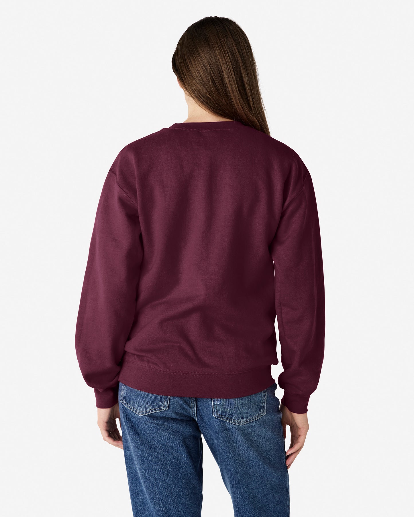 Back view of woman wearing maroon unisex Gildan Heavy Blend Adult Sweatshirt with hair draped over right shoulder