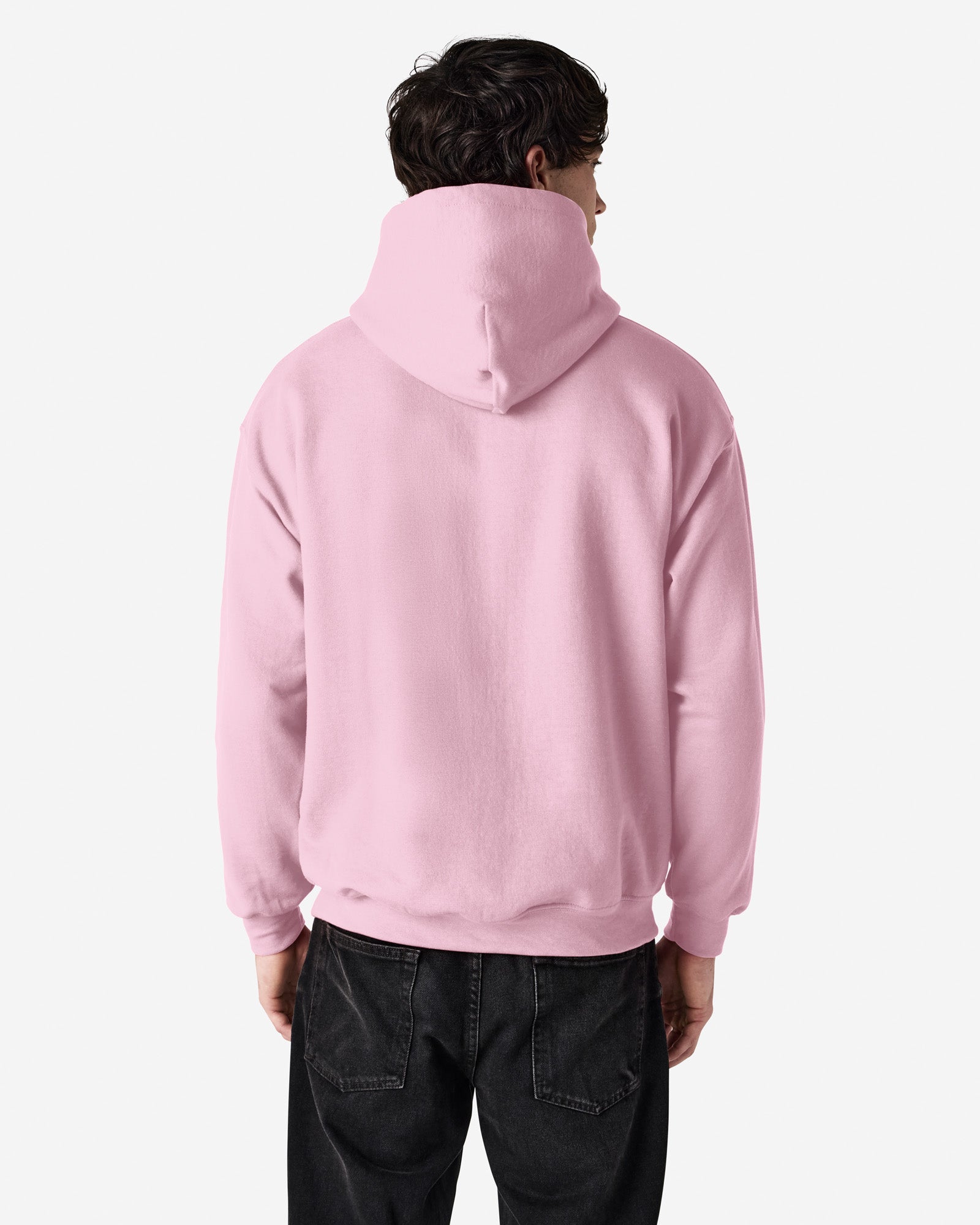 Back view of man wearing light pink Gildan Heavy Blend Adult Hoodie looking to the right