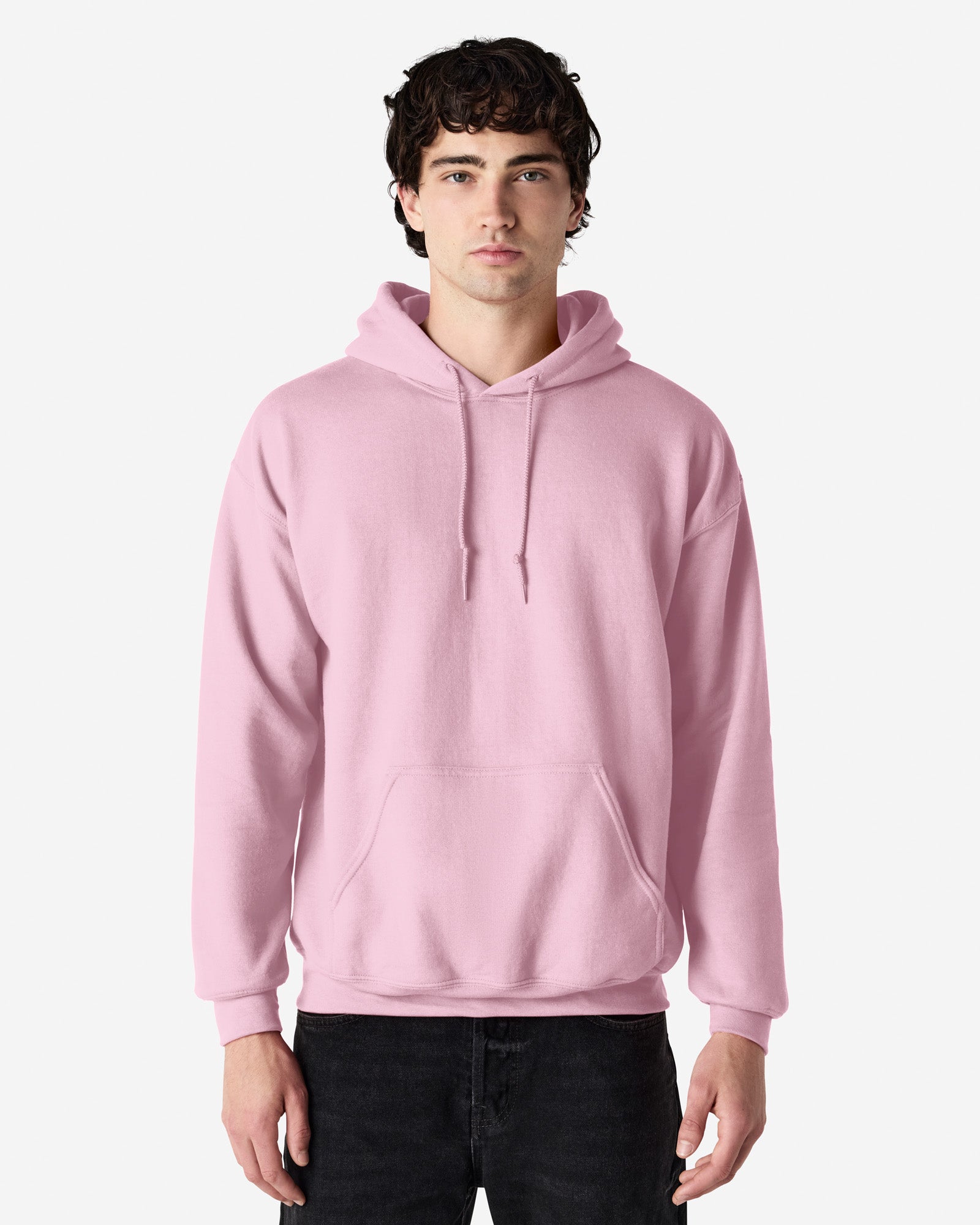 Front view of man wearing light pink Gildan Heavy Blend Adult Hoodie looking straight ahead