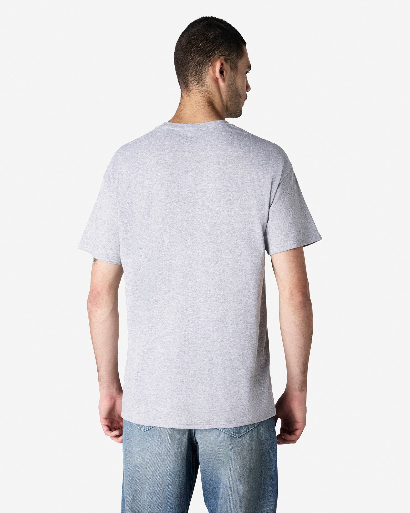 Back view of man wearing light grey Gildan Light Cotton Adult T-shirt looking slightly right