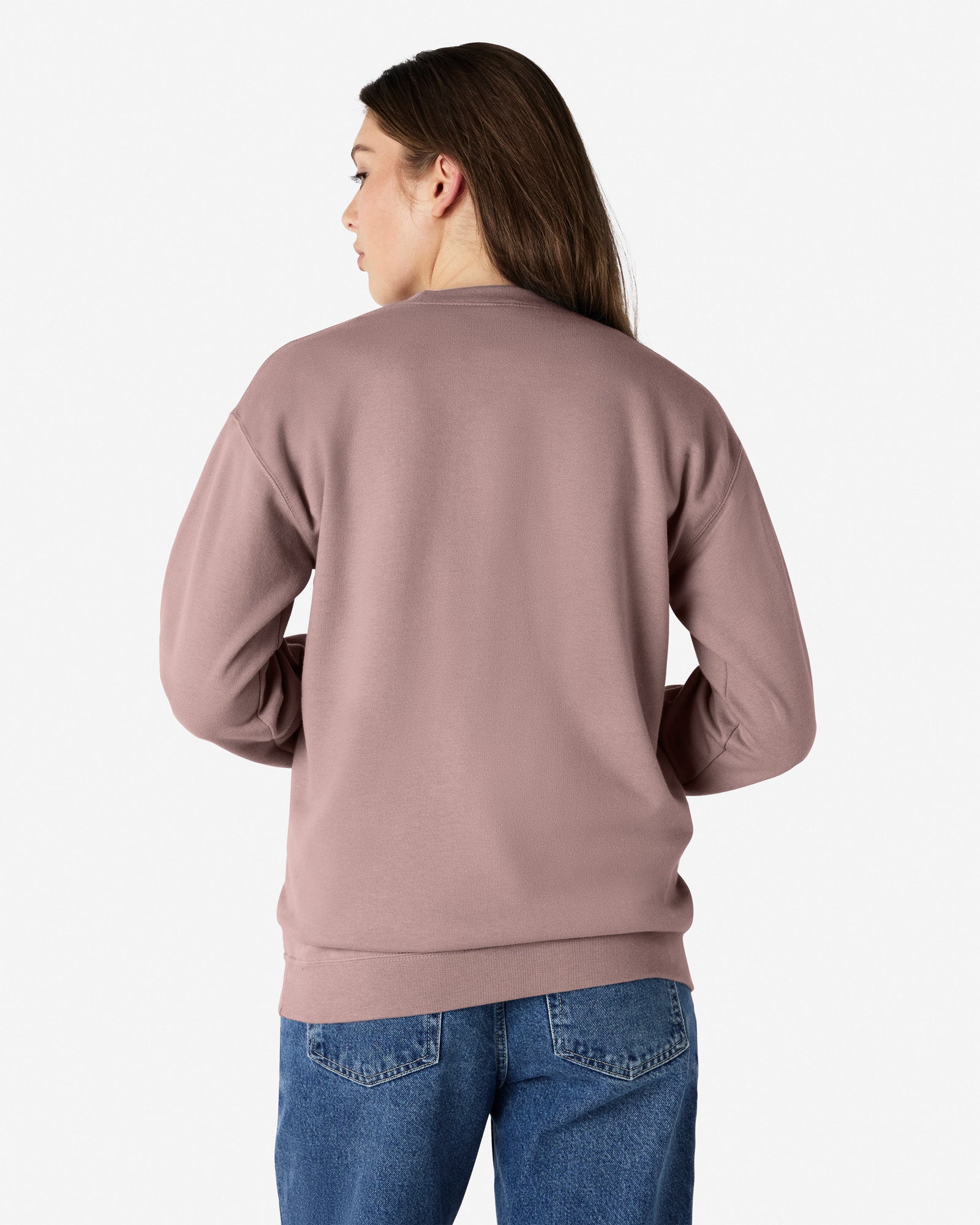 Back view of woman wearing Gildan Softstyle Adult Crewneck Sweatshirt looking left with hair over right shoulder