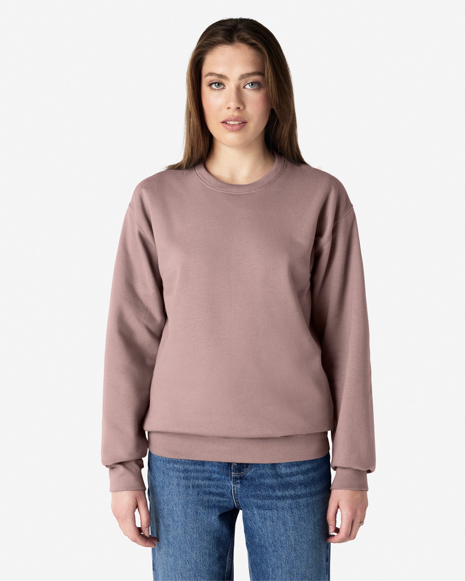 Front view of woman wearing the Gildan Softstyle Adult Crewneck Sweatshirt looking straight ahead with arms by side